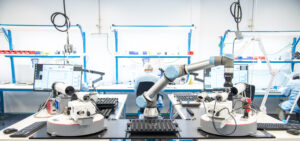 Optikos LensCheck™ system featuring a collaborative robot (cobot) for automated high-volume lens testing demonstration at Photonics West 2026.